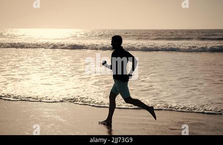 sportive man running on beach. energetic summer. runner feel freedom. hurry up. endurance Stock Photo