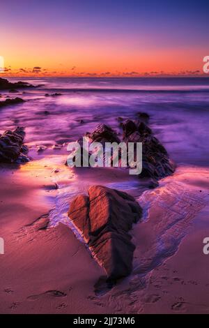 Golden rising sun light on One Mile beach in FOrster coastal town of Australia - pacific ocean seascape. Stock Photo