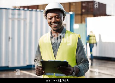 His ideas are revolutionary. a young construction site worker checking his clipboard. Stock Photo