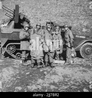 United States Army Troups during the Korean War - Circa 1952. A groupd of men in front of vehicle. Written on back of photo 'passing on the latest scuttlebut'. From the collection of Henry G. Shebley Stock Photo