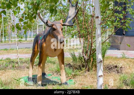 the figure of an elk stands on the lawn Stock Photo