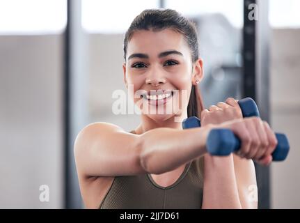 Achieving Fitness Goals Energetic Young Female Engages In Dumbbell