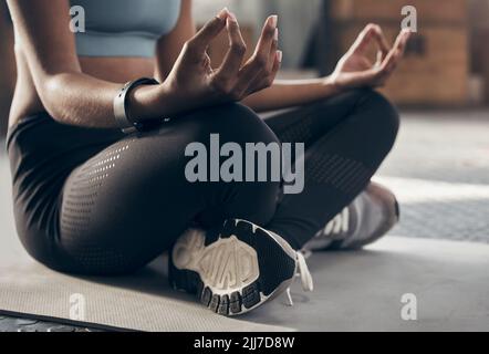 Make your day more zen. Closeup shot of an unrecognisable woman meditating in a gym. Stock Photo