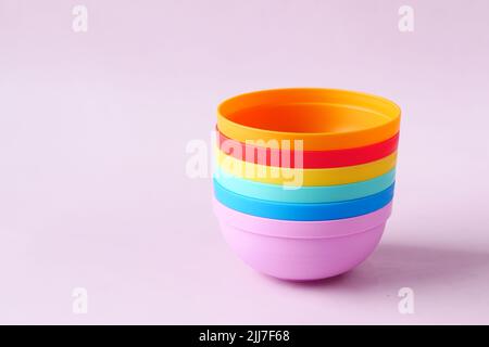 putting empty colorful bowl on table  Stock Photo