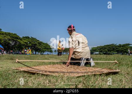 Raha, Indonesia. 23rd July, 2022. One of the ancient kite owners prepares his kite. The Kaghati Kolope or ancient kite is the oldest kite in the world, aged 4 thousand years, based on historical discoveries found in one of the caves on the island of Muna, Southeast Sulawesi. All the constituent parts of this ancient kite are composed of materials derived from nature where the main ingredient is kolope leaves. Credit: SOPA Images Limited/Alamy Live News Stock Photo