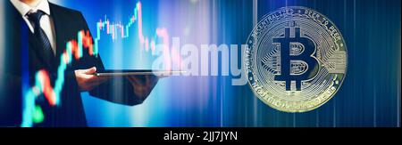 BTC Cryptocurrency Coins.Golden bitcoins with Candle stick graph chart and digital background. Stock Photo