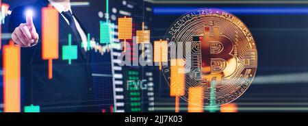 BTC Cryptocurrency Coins.Golden bitcoins with Candle stick graph chart and digital background. Stock Photo