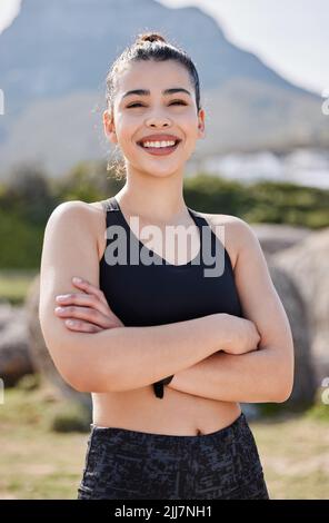 Killer confidence, killer workout. Portrait of a confident young woman going for a run in the park. Stock Photo