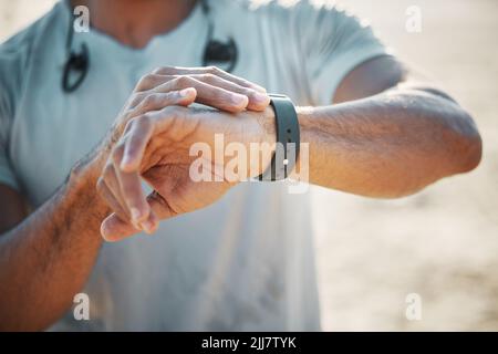 A champion is someone who gets up when they cant. a unrecognizable man using his watch to track his pulse while out for a workout. Stock Photo