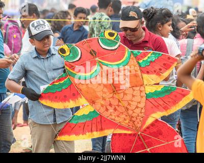 Father and son preparing a kite during the Derana International Kite Festival at Galle Face Green in Colombo, Sri Lanka, 19 August 2018. Stock Photo