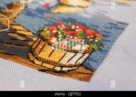 Macro closeup photo of the details of the cross-stitch work with partial focus Stock Photo