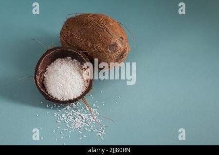 Whole coconut with coconuts flakes on a blue background Stock Photo