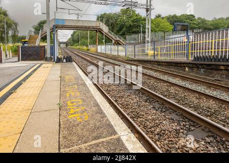 Longport, Stoke on Trent United kingdom July 21 2022 railway lines going of to the distance mind the gap sign on platform floor , empty staition Stock Photo