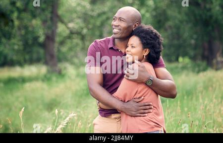 Its so beautiful out here. an affectionate couple spending time together outdoors. Stock Photo