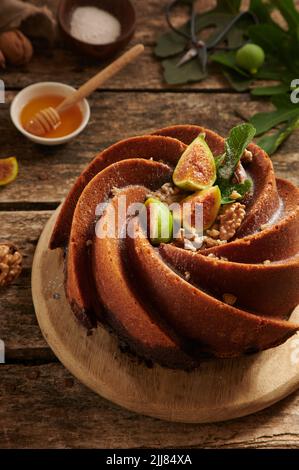 From above of sweet freshly bake cake made of figs with creative decoration served on cutting board in light kitchen Stock Photo