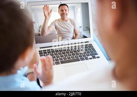 Technology can bring us together. a unrecognizable boy and his father using a laptop for a video call at home. Stock Photo