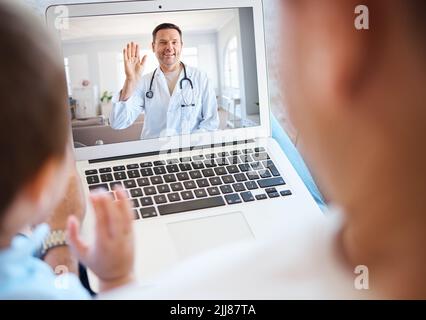 Time for a checkup. a unrecognizable boy and his father using a laptop for a video call at home. Stock Photo