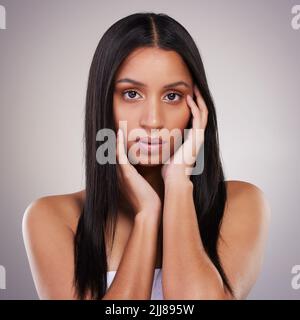 Feeling extra confident today. an attractive young woman posing alone in the studio. Stock Photo