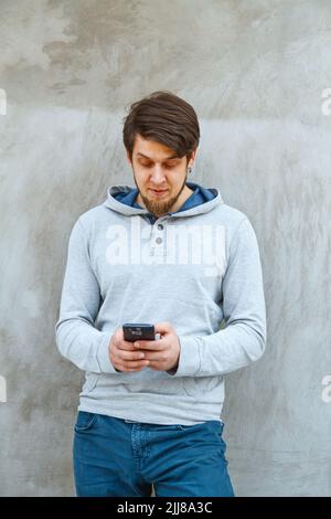 Young man writing sms Stock Photo