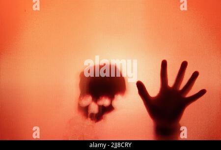 Horror ghost figure behind the matte glass. Halloween festival concept. Stock Photo