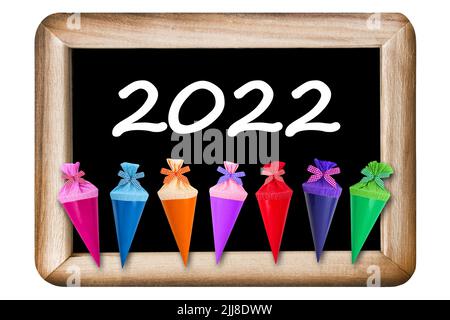 Colorful gifts and school chalk board 2022 isolated on white background Stock Photo