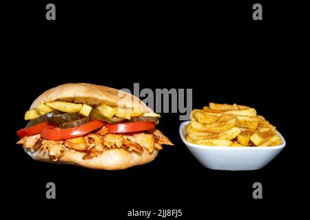 Döner chicken sandwich or Sandviç döner with french fries Isoläted on a black background Stock Photo