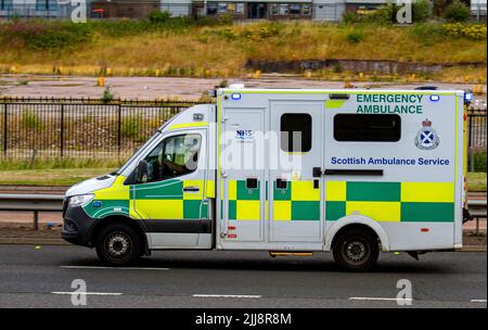NHS Scottish Ambulance Service emergency ambulance responding to an emergency 999 call along on the Kingsway West Dual Carriageway in Dundee, UK Stock Photo