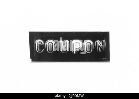 Black color banner that have embossed letter with word coupon on white paper background Stock Photo