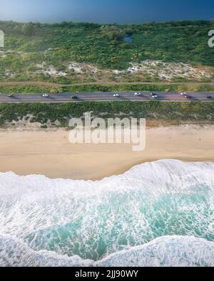 Aerial view of road with beach, sea waves, lake and nature at Barra da Tijuca - Rio de Janeiro, Brazil Stock Photo