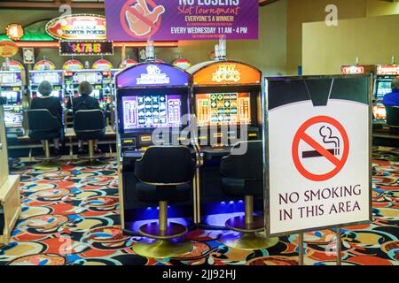 Las Vegas Nevada,Westgate Las Vegas Resort & Casino,inside interior gambling slot machines,sign no smoking symbol,visitors traveling vacation people Stock Photo