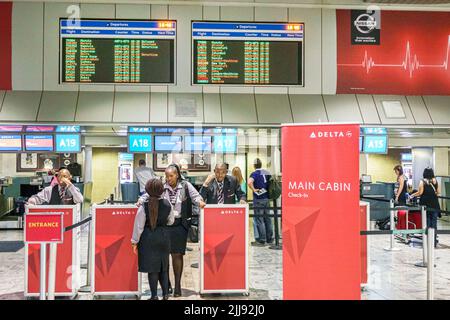 Johannesburg South Africa,Tambo International Airport terminal ticketing check-in counter,Delta Airlines,Black man male women female agents departures Stock Photo