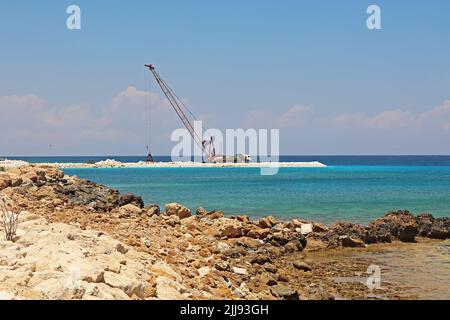 Construction work is underway on the coast of the sea Stock Photo