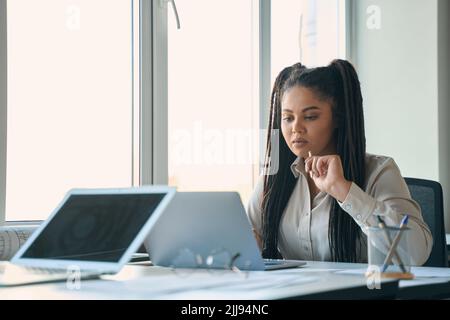 Focused design professional using her portable computer Stock Photo