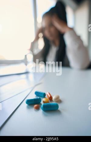 Office worker suffering from headache in workplace Stock Photo