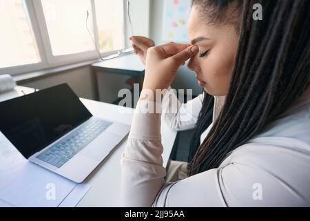 Modern office worker suffering from work overload Stock Photo