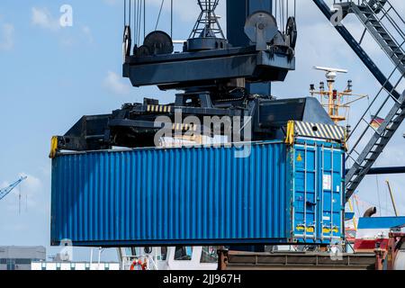 40 ft intermodal container being lifted by spreader in seaport Stock Photo