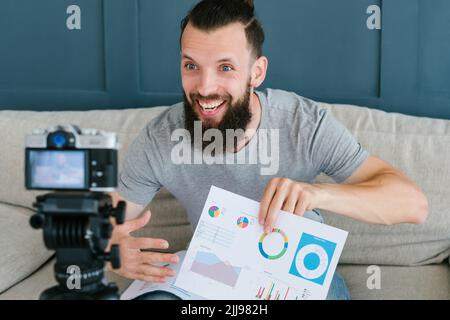 blogger success business smiling man papers graphs Stock Photo