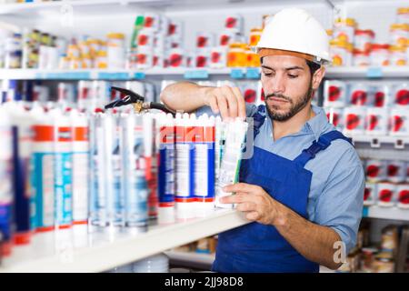 Concentrated handyman choosing materials Stock Photo