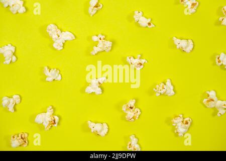 Popcorn on a yellow background, close-up view from above Stock Photo