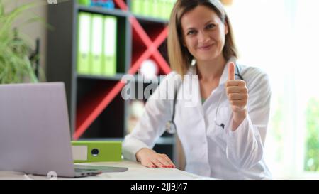 Happy smiling female practitioner showing thumb up gesture Stock Photo