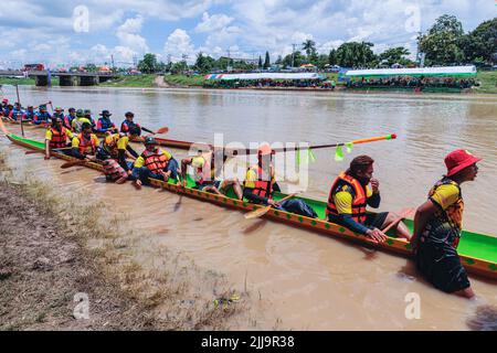 About 50 men on long boats paddle to the finish line as they race on ...