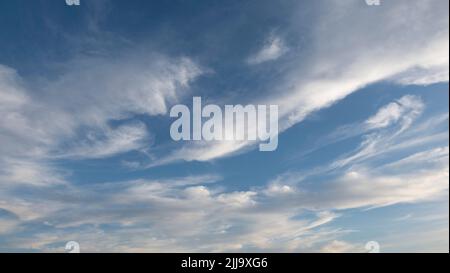 Beautiful wind shaped clouds and blue sky for background use or sky substitution Stock Photo