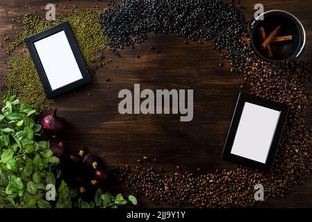 Dark wooden background with a culinary theme. The view is strictly from above. A scattering of pine nuts, black and green beans, dried red onions, two Stock Photo