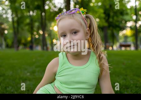 Sweet child poses in garden Stock Photo - Alamy