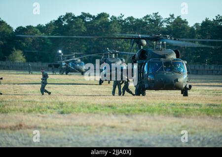 U.S. Army Soldiers with the 404th Civil Affairs Battallion exit a Black Hawk (UH-60) Helicopter during Operation Viking at Joint Base Cape Cod, Mass., July 20, 2022. Operation Viking is an intense joint task force exercise designed to prepare Soldiers with realistic training simulating deployment of civil affairs units in direct support of a contingency operation in Africa. (U.S. Army Photo by Staff Sgt. Keith Thornburgh) Stock Photo