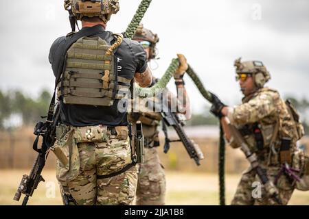 U.S. Army Special Operations Soldiers conduct fast rope insertion training aboard a Black Hawk (UH-60) helicopter operated by pilots with the 8-229 Assault Helicopter Battalion, 244th Expeditionary Air Combat Brigade, during Operation Viking at Joint Base Cape Cod, Mass., July 18, 2022. Operation Viking is an intense joint task force exercise designed to prepare Soldiers with realistic training simulating deployment of civil affairs units in direct support of contigency operation in Africa. Stock Photo