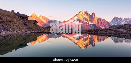 Colourful sunset on Lac Blanc lake in France Alps. Monte Bianco mountain range on background. Vallon de Berard Nature Preserve, Chamonix, Graian Alps. Landscape photography Stock Photo