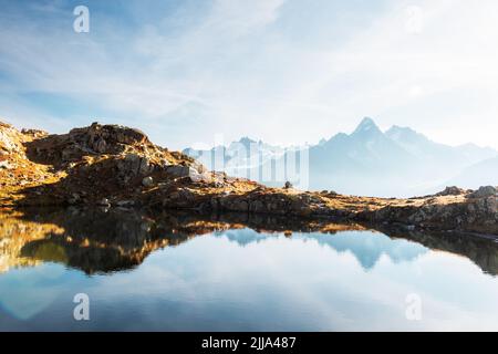 Colourful sunset on Chesery lake (Lac De Cheserys) in France Alps. Monte Bianco mountain range on background. Vallon de Berard Nature Preserve, Chamonix, Graian Alps. Landscape photography Stock Photo