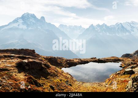 Colourful sunset on Chesery lake (Lac De Cheserys) in France Alps. Monte Bianco mountain range on background. Vallon de Berard Nature Preserve, Chamonix, Graian Alps. Landscape photography Stock Photo