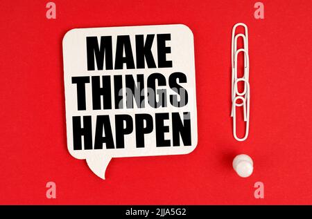 Business concept. On a red background, paper clips are an exclamation mark and a thought plate with the inscription - Make things happen Stock Photo